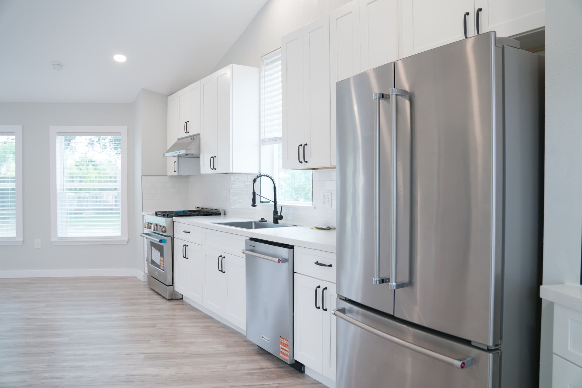 Full kitchen with stainless appliances and shaker cabinetry