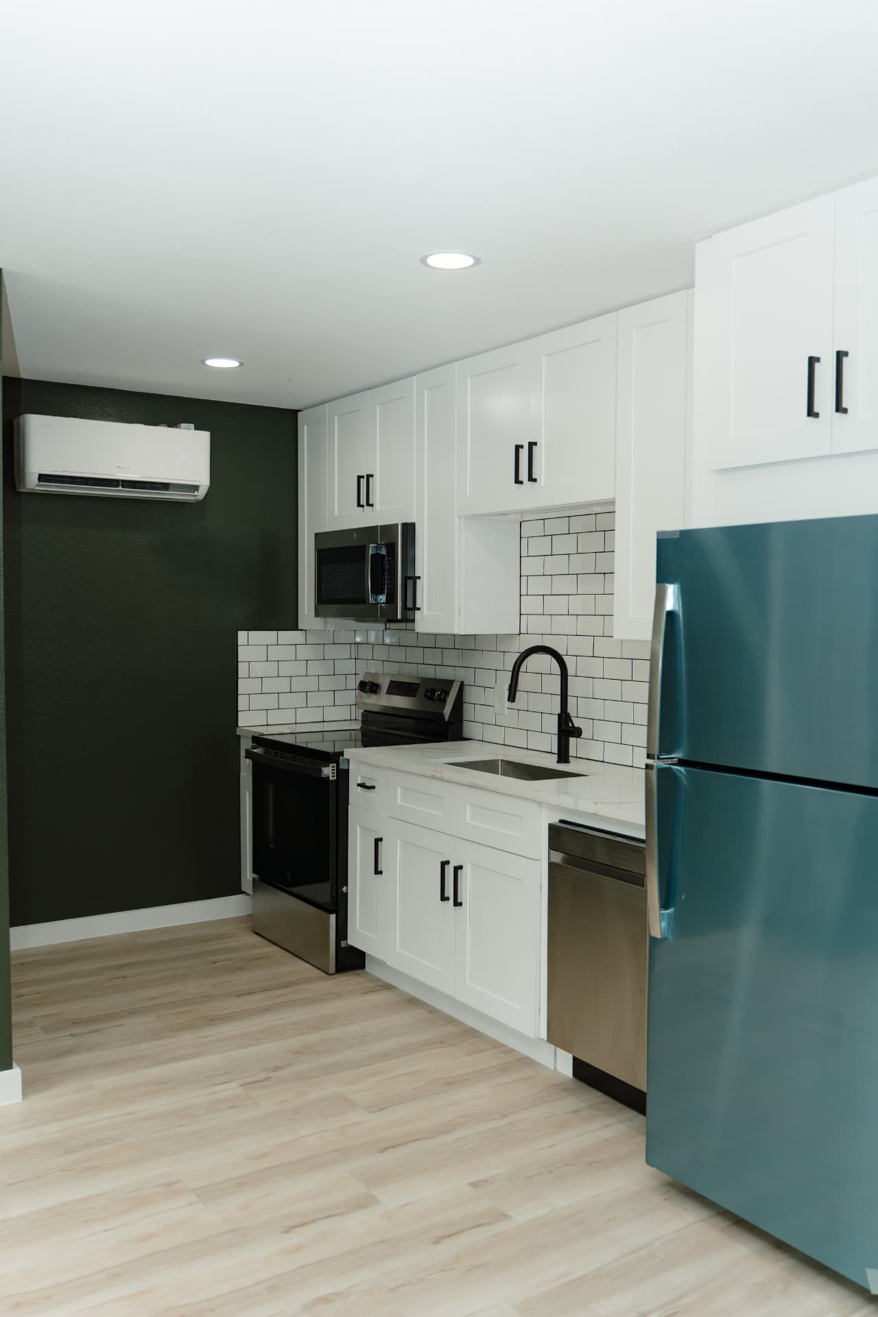 Kitchen with mini-split HVAC and full appliance package