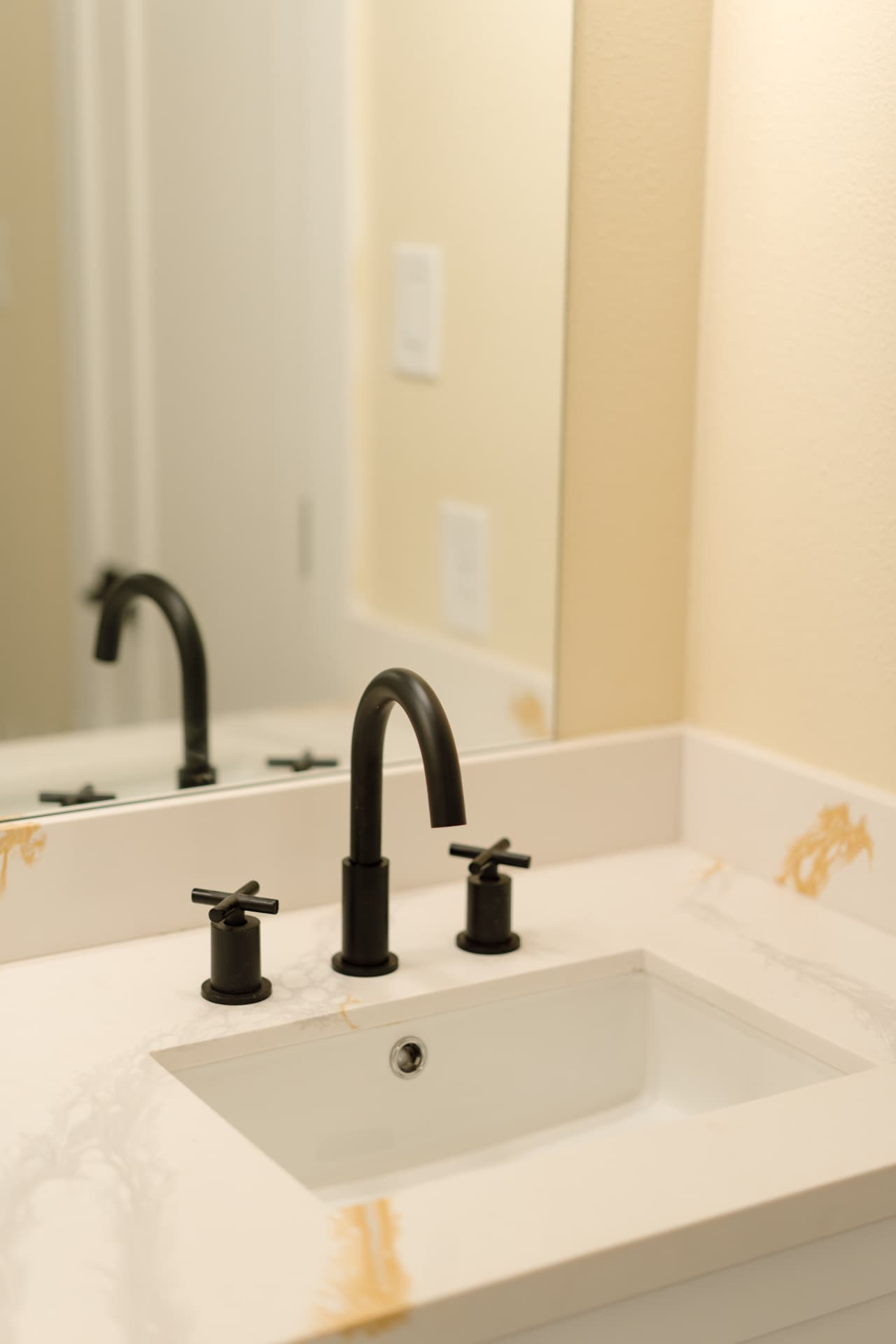 Quartz vanity with matte black widespread faucet