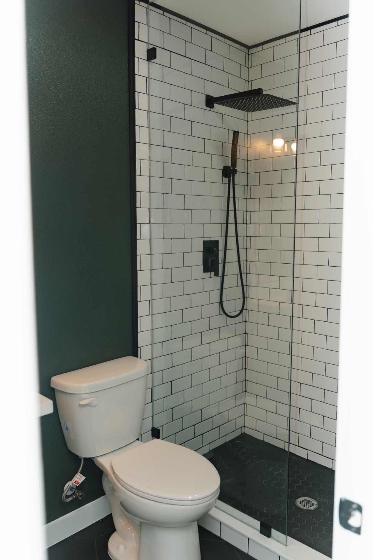 Tiled walk-in shower with matte black fixtures